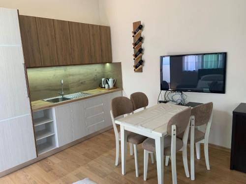 a kitchen with a table and chairs and a sink at VILA 32 in Berat