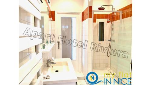 a bathroom with a white sink and a shower at ApartHotel Riviera - Liberte 1 - Grimaldi Promenade des Anglais 5mn - Supérieur 2 chambres AC - Emplacement Exceptionnel in Nice