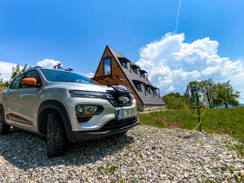 a silver truck parked in front of a house at Cabana Galaxy A Frame by Cabanele Galaxy in Cucuteni