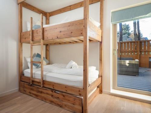 a bedroom with two bunk beds with a window at The Neuk in Kincraig