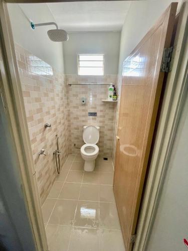 a bathroom with a toilet and a shower at Aufa Homestay 1 Bilik Aircond in Pendang