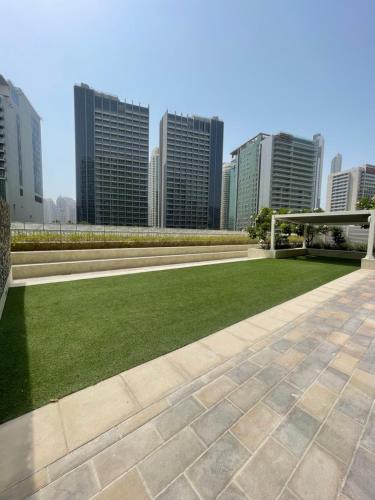 a park in a city with tall buildings at Wonderful Reva Aparthotel Downtown in Dubai