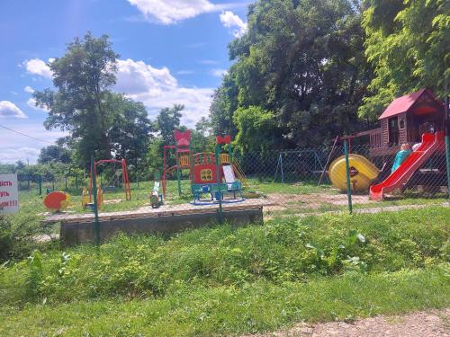 a playground with colorful play equipment in a park at Готель "ГОСТЬОВИЙ ДІМ in Stryj" in Stryi