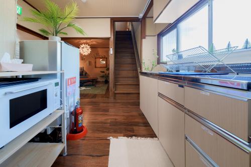 a kitchen with a sink and a dishwasher at R-house 2nd in Higashi-kanagawachō