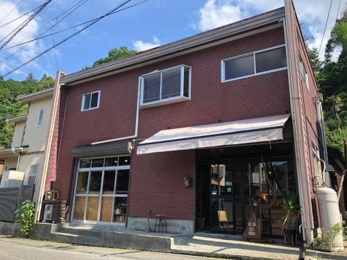 a red brick building on a street at TORUS 修善寺 Condominium 貸切宿 in Izu
