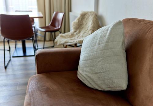 a couch with a pillow on it in a living room at Schima Drosa Apartments - Studios - by Pferd auf Wolke in Gaschurn