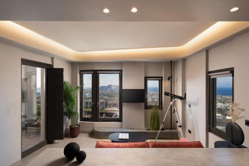 a living room with a view of a city at Apikia Santorini in Pirgos