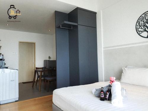 a bedroom with a white bed with a black wall at 1 min to Seaview & Sunrise Heart of Kuantan in Kuantan