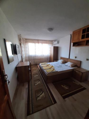 a small room with two beds and a window at Стаи за гости Петрови in Primorsko