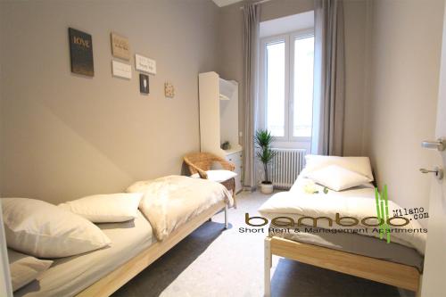 - une chambre avec 2 lits et une fenêtre dans l'établissement Bamboo Milano Umbria Apartment, à Milan