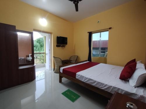 a bedroom with a bed and a window at Mayabon Resort Bolpur in Shānti Niketan