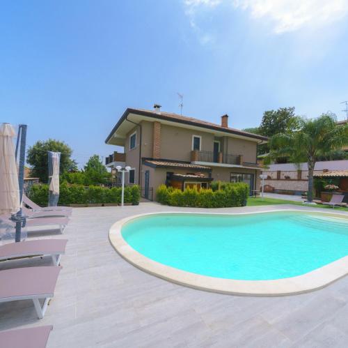a large swimming pool in front of a house at Bedda Mia Etna House B&B in Trecastagni