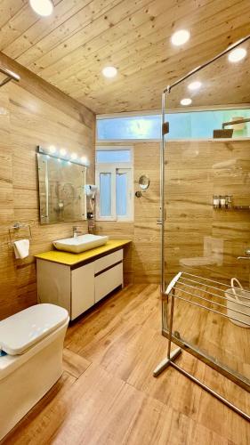 a bathroom with a toilet and a sink and a shower at Clarence Cottage Mussoorie in Mussoorie