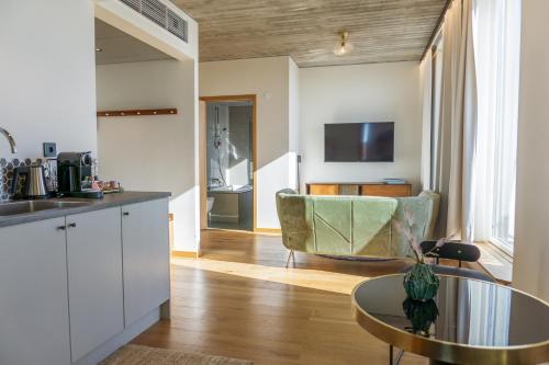 a kitchen and living room with a table and a couch at Fritiden Hotell & Kongress in Ystad