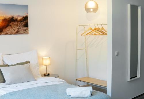 a bedroom with a bed and a table with a lamp at Studio Apartment am Kurpark in Bad Segeberg