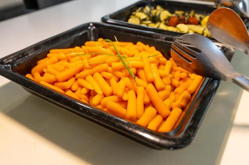 a tray of carrots with utensils in it at Dos Playas - 30º hotels in Puerto de Mazarrón