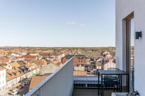 a balcony with a table and a view of a city at Fritiden Hotell & Kongress in Ystad