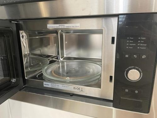 a microwave with a plate inside of it at New 2A Soho Studios by Indigo Flats Sleeps 4 in London