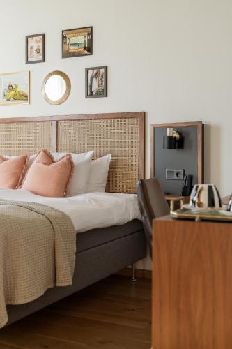 a bedroom with a bed and a desk with a phone at Fritiden Hotell & Kongress in Ystad