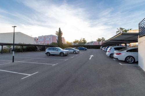 a parking lot with several cars parked in it at Dos Playas - 30º hotels in Puerto de Mazarrón