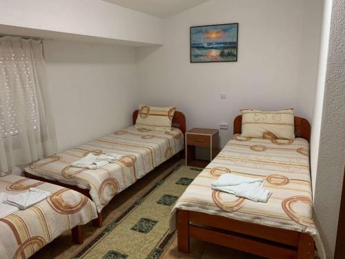 a room with three beds and a window at Royal L Hotel in Carev Dvor