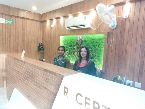 a man and a woman standing in front of a mirror at HOTEL SJ PREMIUM in Bhubaneshwar