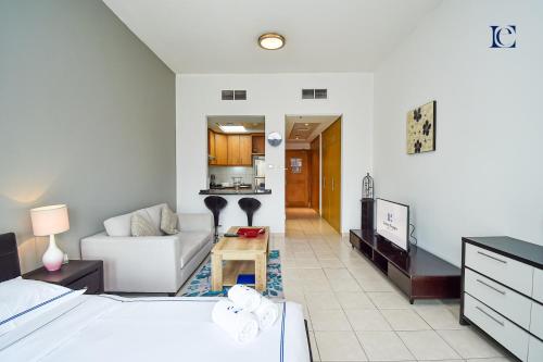 a bedroom with a bed and a living room at Luxury Escapes - Tranquil Studio Near Furjan Metro - Relaxing Holiday Retreat in Dubai