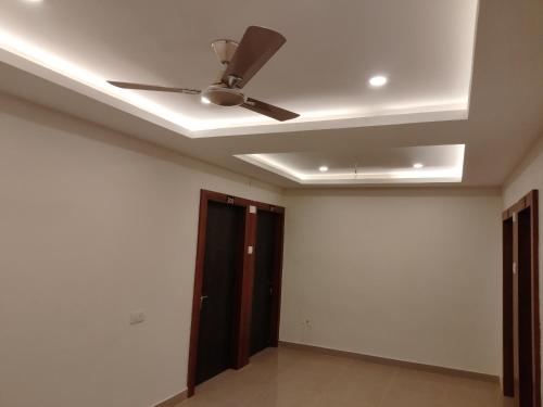 a ceiling fan in a room with a door at HOTEL SJ PREMIUM in Bhubaneshwar