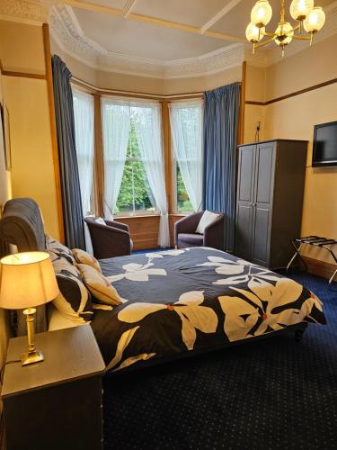 sypialnia z dużym łóżkiem i oknem w obiekcie Smiths Guest House w Edynburgu