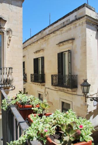 a group of potted plants on a balcony at Palazzo della Contessa - Suites & Breakfast in Lecce