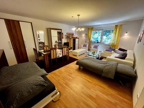 a bedroom with a bed and a living room at Wohnung in bester Lage von Witten in Witten
