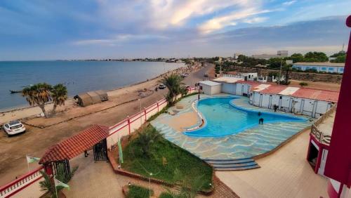 a view of a swimming pool next to a beach at SIESTA HOTEL in Djibouti