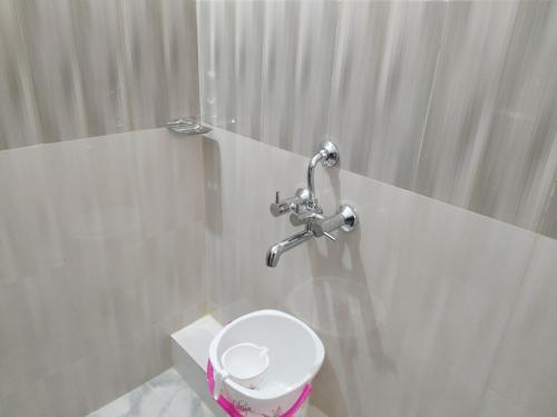 a bathroom with a toilet and a shower at HOTEL SJ PREMIUM in Bhubaneshwar