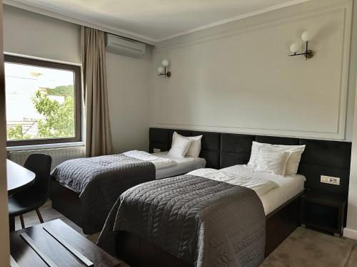 Ένα ή περισσότερα κρεβάτια σε δωμάτιο στο Hotel Ramina