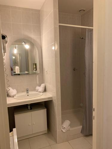 a bathroom with a sink and a shower at Hôtel U Pozzu in Sisco