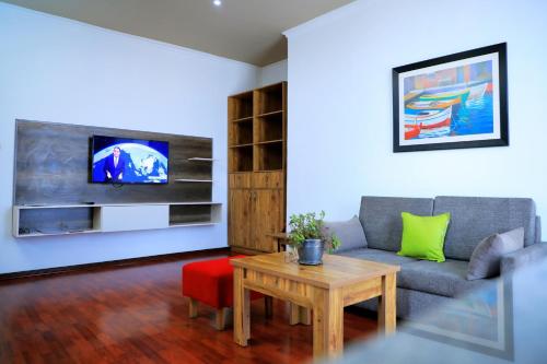 a living room with a couch and a table at Victoria Guesthouse Addis in Addis Ababa