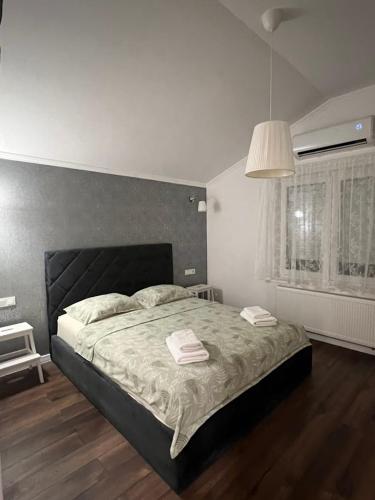 a bedroom with a bed with two towels on it at Exclusive apartment in Supetarska Draga