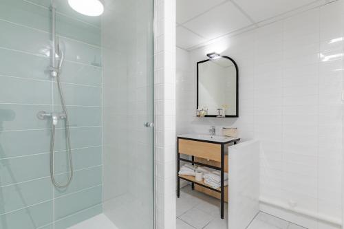 a bathroom with a shower and a sink and a mirror at Appart'City Classic Bordeaux Centre in Bordeaux