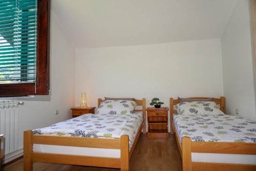 two twin beds in a room with a window at VIP Rooms Foča, Accommodation Foca, Foca Rooms in Foča