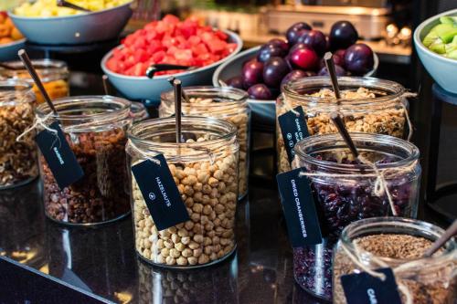 a group of jars filled with nuts and other foods at The Hotel Brussels in Brussels