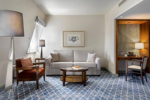 a living room with a couch and a table at Warwick Grand-Place Brussels in Brussels