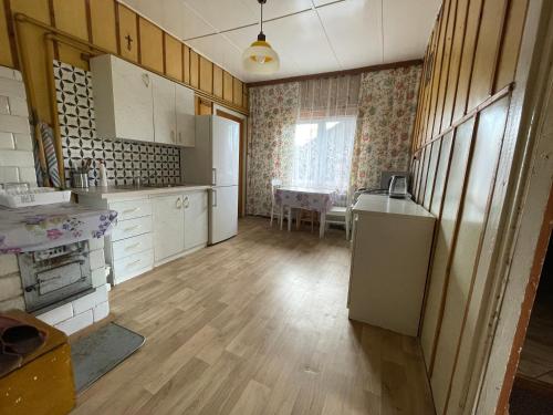 a kitchen with a refrigerator and a table in it at Pod Dębem in Białowieża
