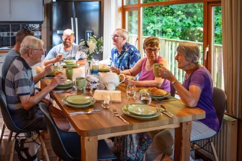 a group of people sitting around a table eating at Watermouth Lodges in Ilfracombe