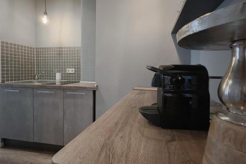 a bathroom with a sink and a chair on a wooden floor at NeuWerk in Erfurt