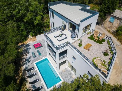 an overhead view of a house with a swimming pool at Wellness villa Modruna in Grižane