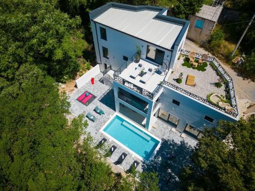 an overhead view of a blue house with a swimming pool at Wellness villa Modruna in Grižane