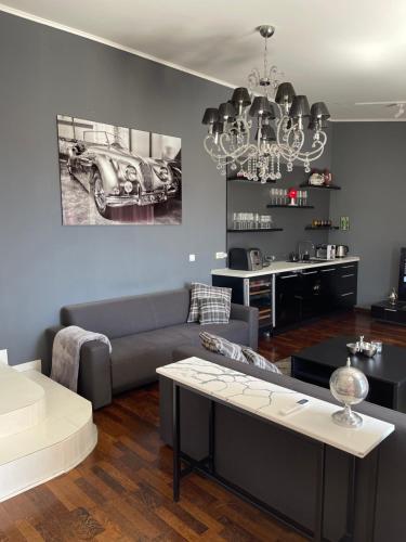 a living room with a couch and a car on the wall at Holiday Home Barska Vila in Bar