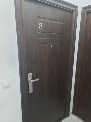 a wooden door with the number eight on it at Nino Lux Apartments Ulcinj in Ulcinj