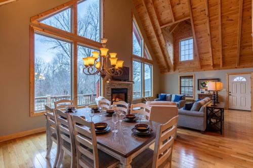 a dining room with a table and a fireplace at Mayapple Ridge in Sugar Grove