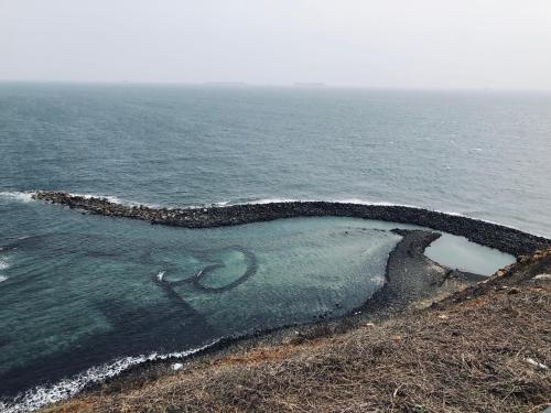 an island in the ocean with a heart drawn on it at Muchen BnB in Magong